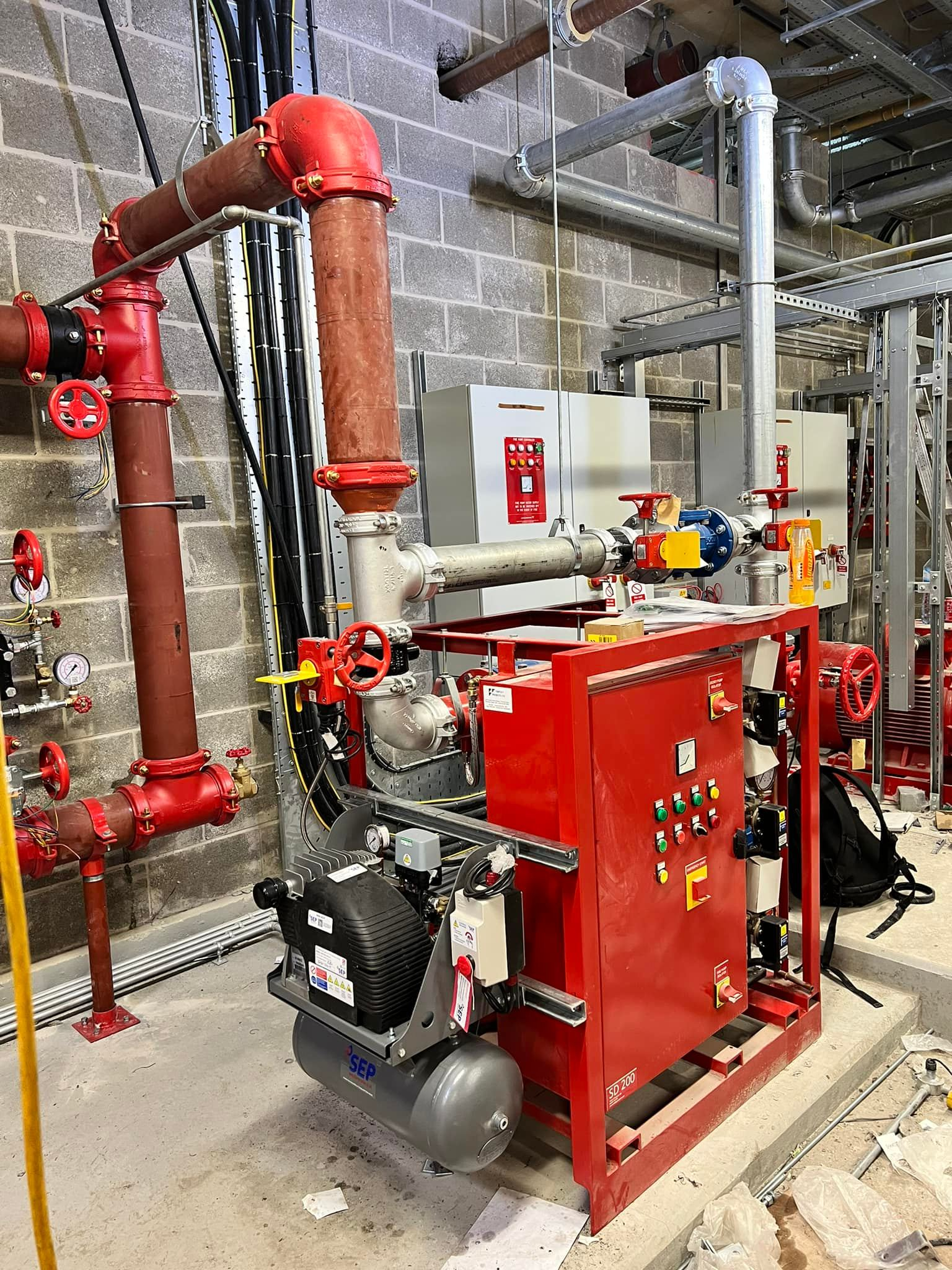 Engineer testing sprinkler system controls for certification and reporting